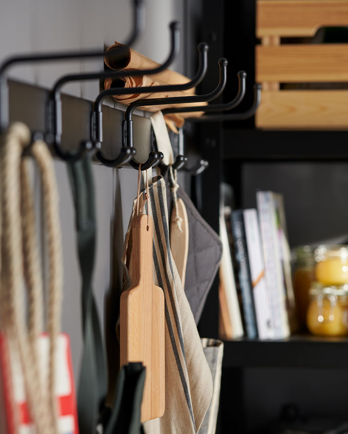 PINNIG rack with RINNIG mitts and a KNAGGLIG box forming a functional spot to hang kitchen tools and accessories.