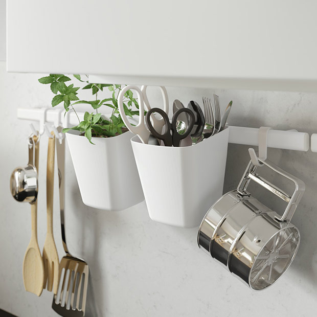 Organized kitchen wall with SUNNERSTA rail system, GRUNKA utensils, MÄRKBART scissors, VARDAGEN measuring cups and IDEALISK sieve.