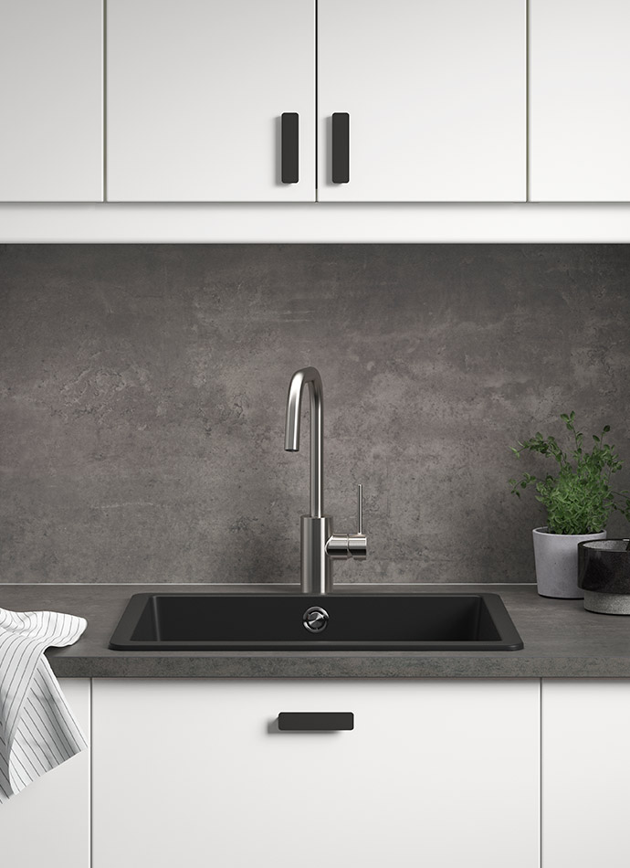 Modern kitchen with white cabinets, black sink, metallic faucet, and dark wall. Minimalist and elegant.
