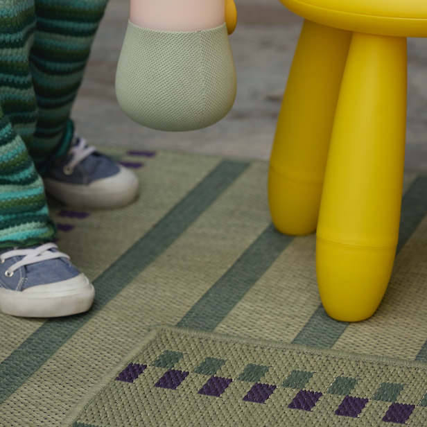 The feet of a child can also be seen in front of the legs of a yellow stool.