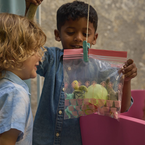 Children playing with a safety bag there are toys inside