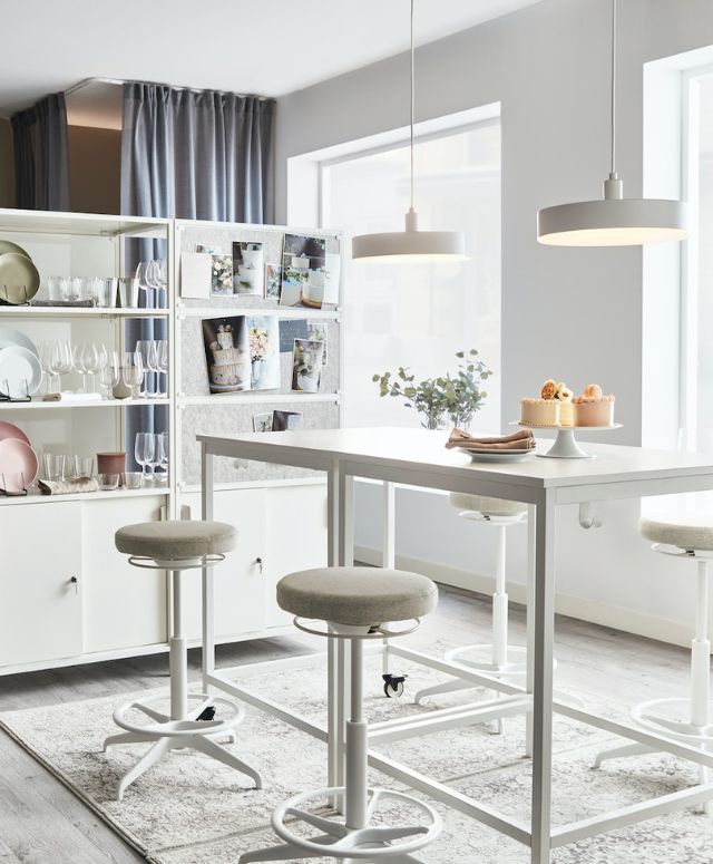 Home office illuminated by natural light, furnished with TROTTEN desks and cabinets.