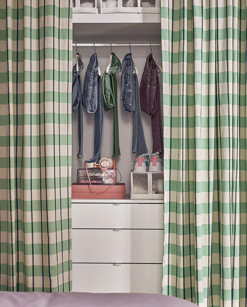 accessories for organizing bedroom clothes, all covered with a green checkered curtain.