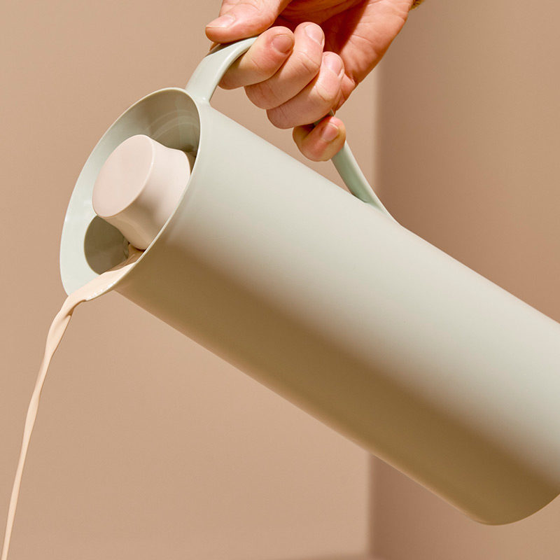 a thermal jug pouring milk
