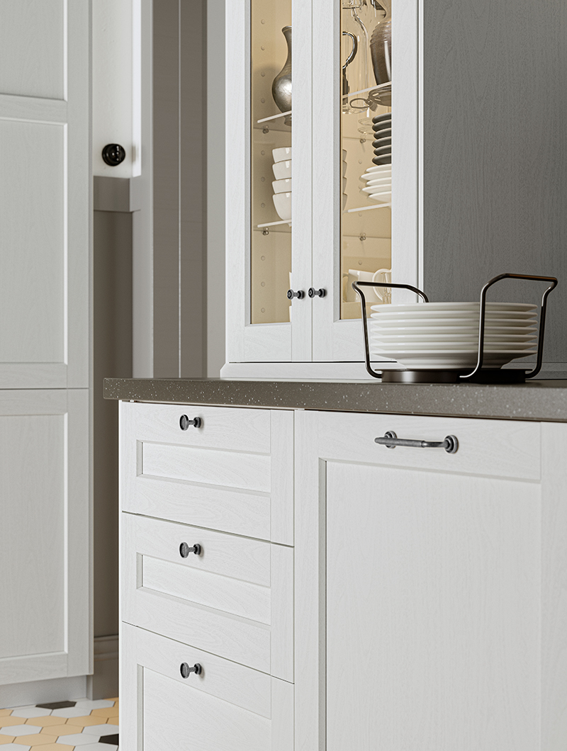 White METOD base cabinet with SKRUVSHULT knobs and UPPDATERA plate holder on the countertop.
