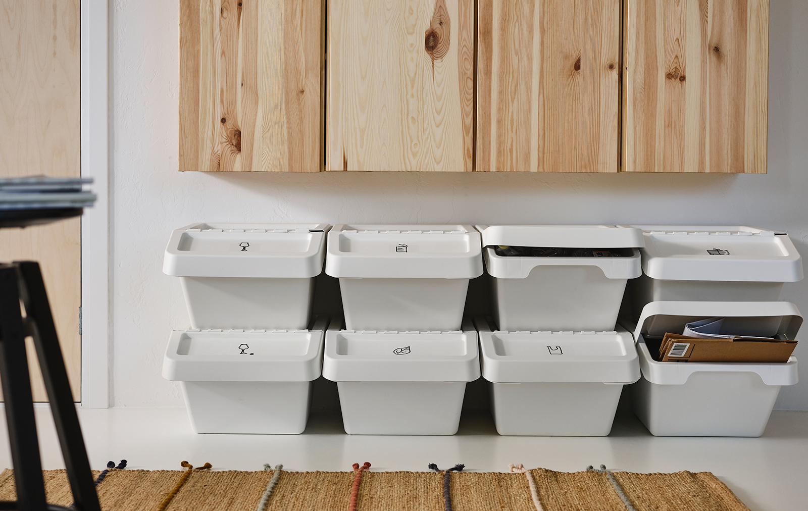A wall cabinet with IVAR doors, several stacked SORTERA recycling bins, and a RAKLEV rug.