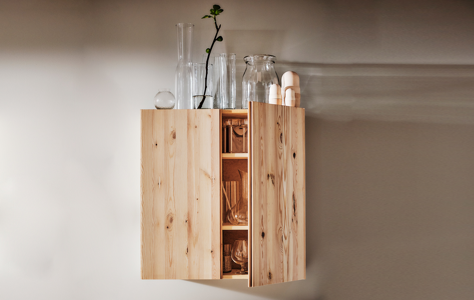 An IVAR wooden cabinet with a BEGARLIG vase and a set of 3 CYLINDER vases.