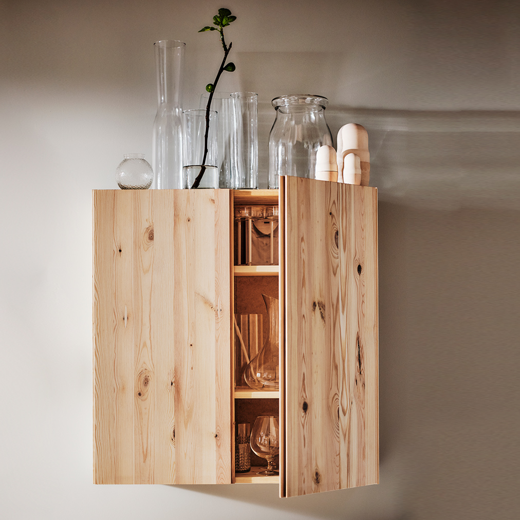 An IVAR wooden cabinet with a BEGARLIG vase and a set of 3 CYLINDER vases.