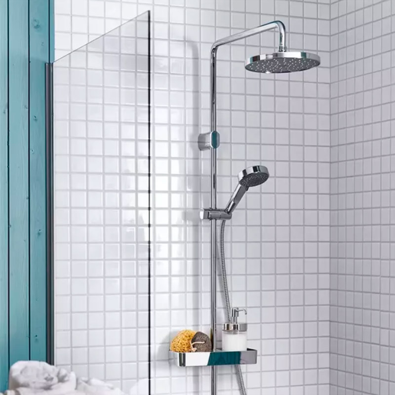Head/hand shower kit with diverter and white tiled walls, featuring a shelf with sponge and soap in a clean, minimal space.