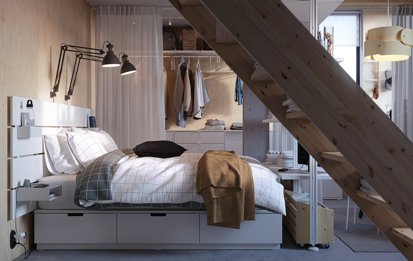 Compact bedroom with white bed, built-in storage, and exposed wooden staircase.