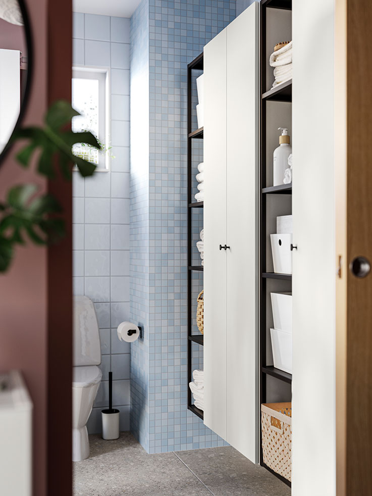 Tall ENHET bathroom cabinets and ENHET shelves with door and paper holder, with a SKOGSVIKEN toilet paper holder in the background.