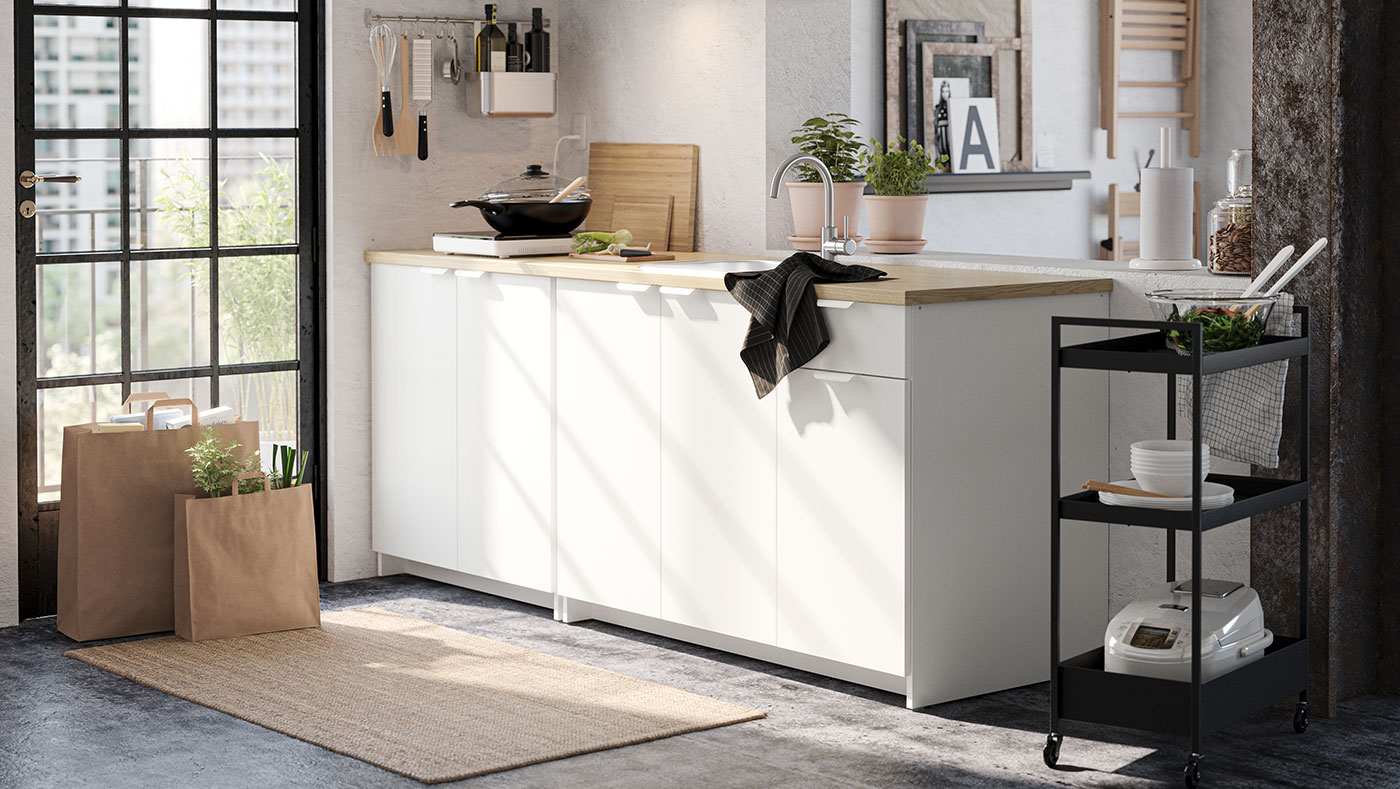 Small kitchen unit together with a black metal kitchen cart