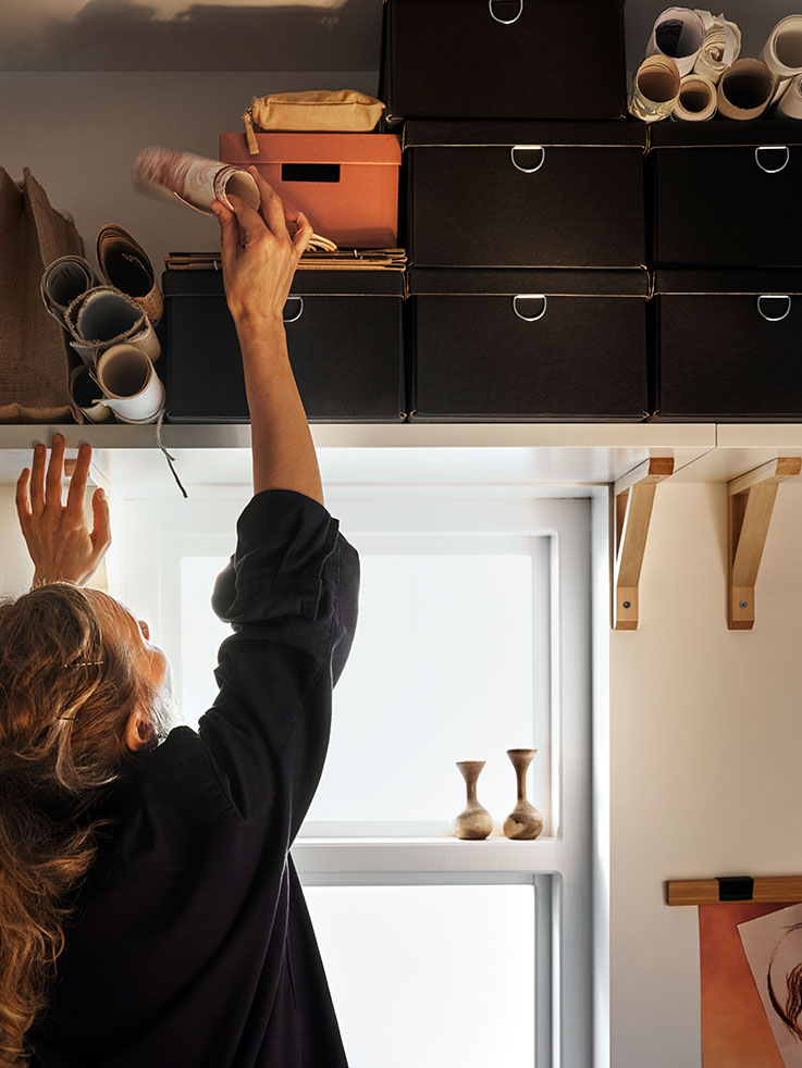 Black boxes on wall shelf