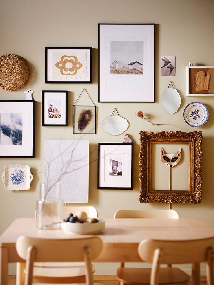 Frames of different sizes in birch tone dining room