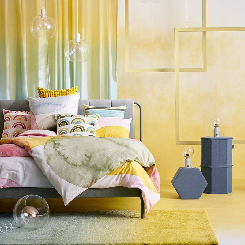 Colorful and artistic modern bedroom, a bed full of cushions and quilts in different colors