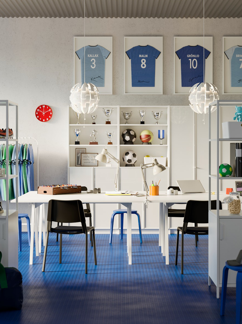 Children's study and creativity room, there are modern bookshelves with books, there are desks with computers and at the back shelves with sports trophies and framed soccer balls and soccer jerseys.