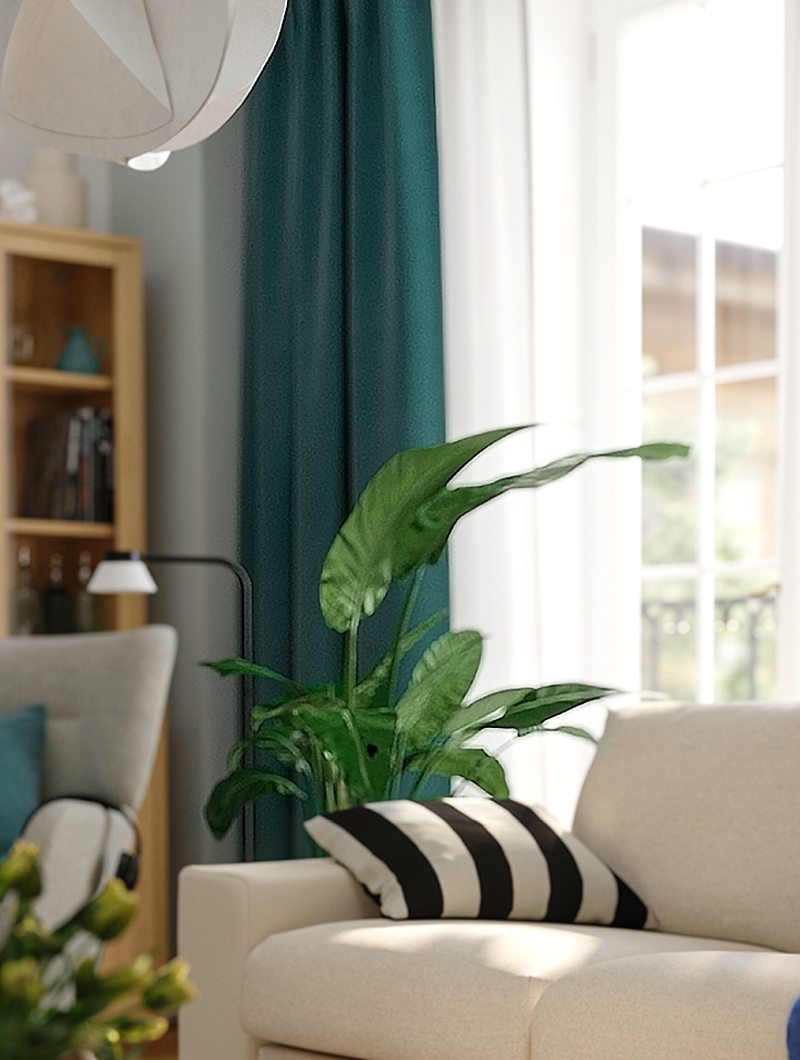  A KIVIK sofa with a FEJKA artificial plant behind it in a living room