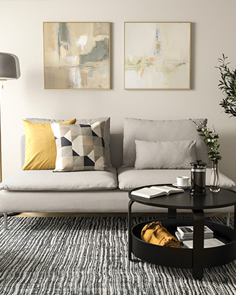 Modern-style gray sofa in a bright living room with beige tones, a round black coffee table.