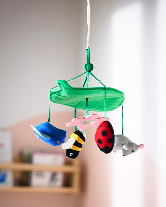 Baby crib mobile with various soft animal-shaped plush figures.