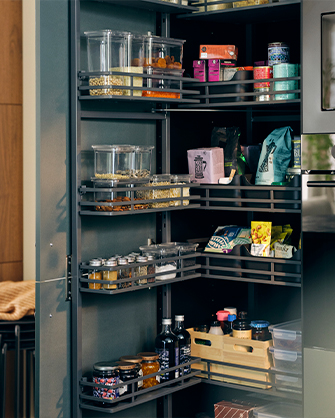 Interior of a kitchen cabinet with UTRUSTA pull-out shelves and solutions, organizing food and bottles. Maximize your pantry space.