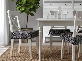 dining room with chairs covered with dark covers