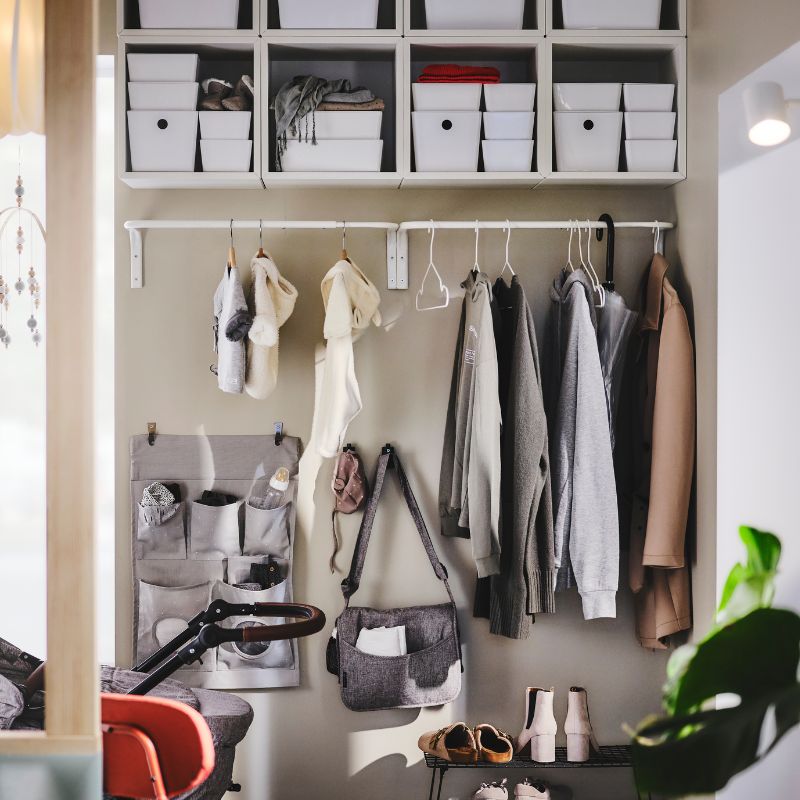 Tidy hallway with organized shelves featuring KUGGIS boxes, EKET wall shelf and LEN hanging storage.