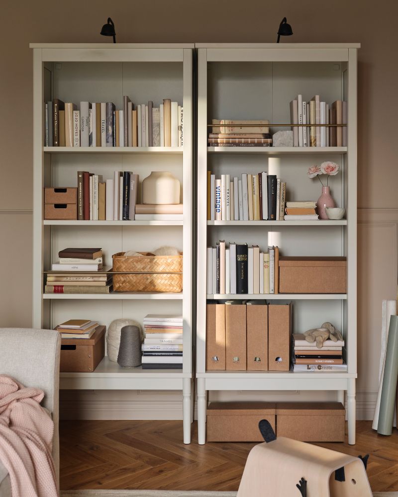 Two FÄRJKARL bookcases with books, GÄRDESGÅRD magazine files and boxes on the shelves and TVÄRDRAG cabinet lighting on top.