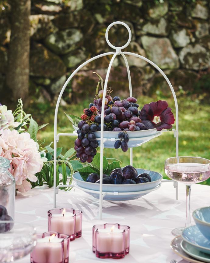 Two glass lanterns with small candles in pastel colors.