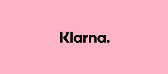 The "Klarna." logo in black typography centered on a solid pink background.