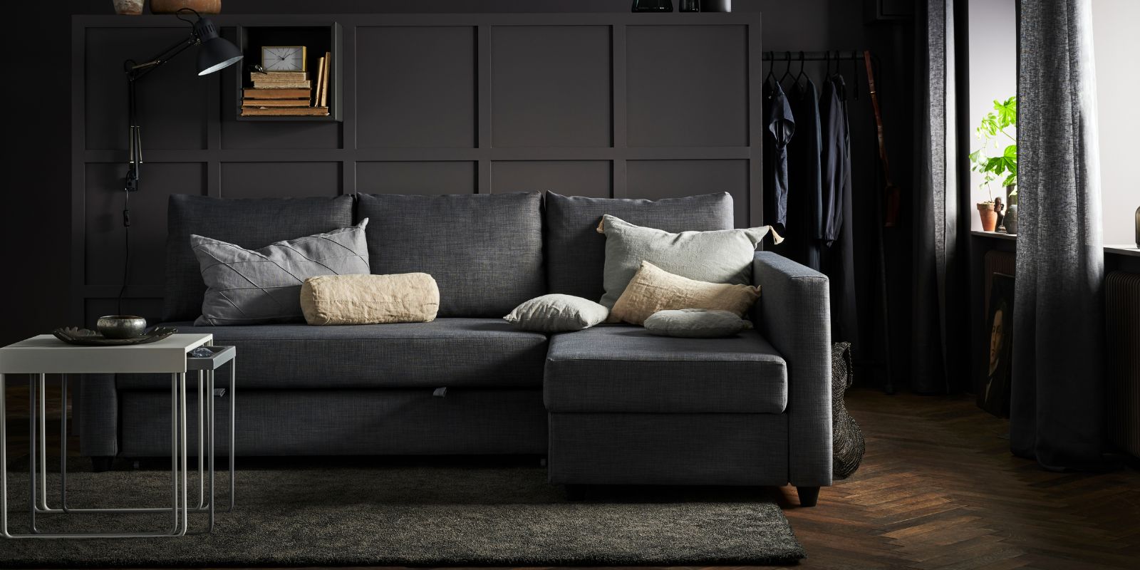 Cozy living room with FRIHETEN sofa bed, STOENSE rug, EKET wall shelf, TERTIAL lamp, TURBO rack and LENDA curtains.
