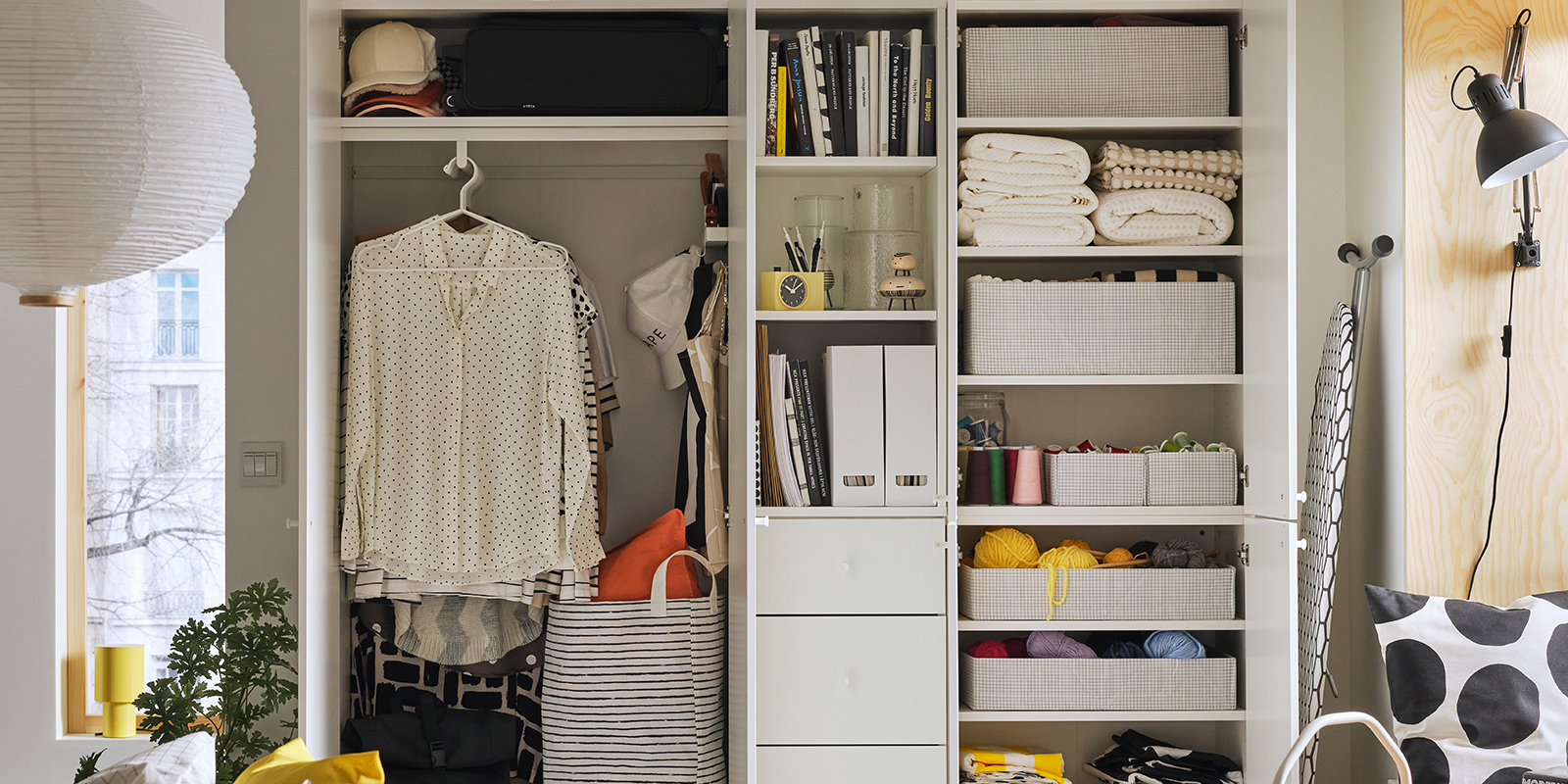 Inside a LASTARE wardrobe combination with STUK boxes on shelves and wire baskets storing neatly folded textiles.