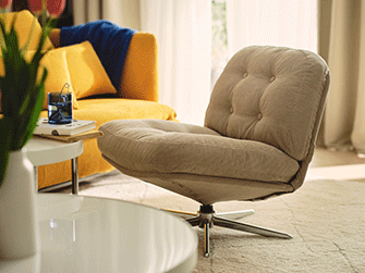 Tufted beige swivel armchair on a light rug, next to a white coffee table and a bright yellow sofa in a cozy living room.