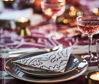 Plate with a decorative napkin on an elegantly set table.