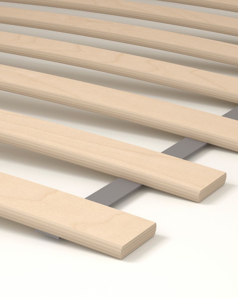 Minimalist bedroom with LURÖY slatted bed base, featuring flexible wooden slats designed for comfort and mattress support.