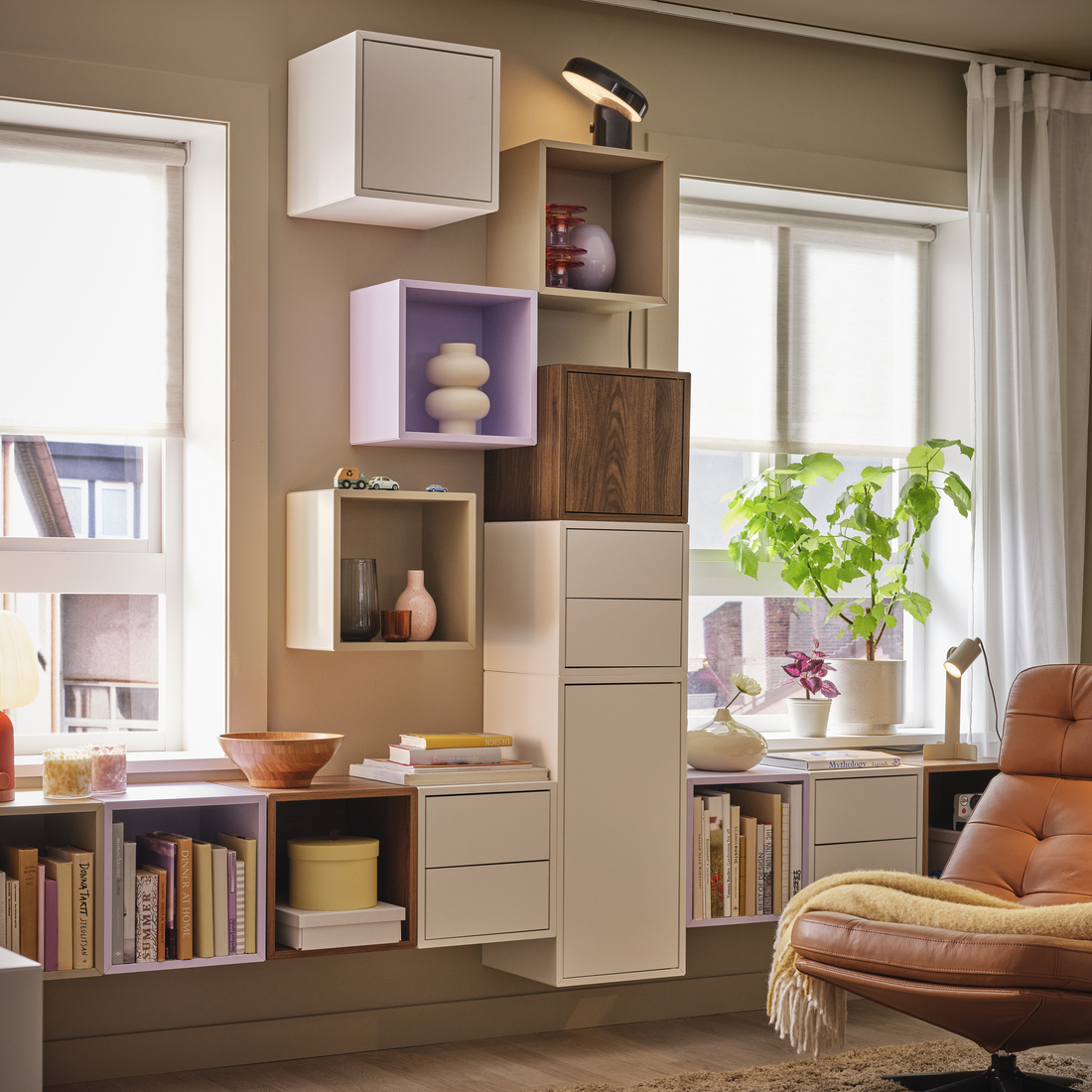 Pastel and wood wall-mounted cube modules forming a modular storage arrangement.