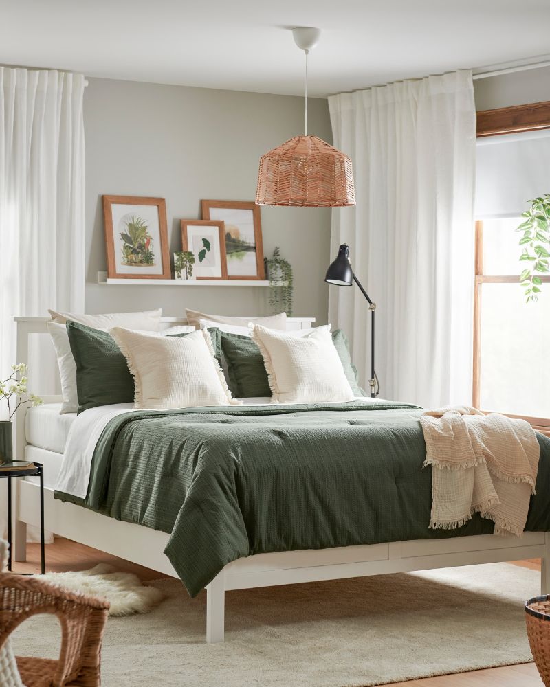 Inviting bedroom with HEMNES queen bed, LUKTVICKER quilt set, VALLKRASSING throw, DYTÅG curtains and STOENSE rug.