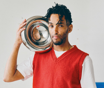 Person holding a metallic decorative piece.