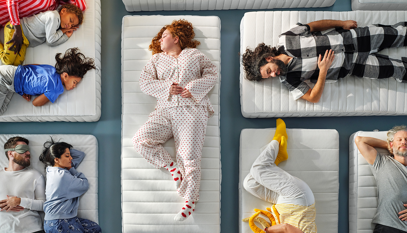 IKEA VALEVÅG mattresses with people relaxing, including one person hugging the BLÅVINGAD octopus soft toy.