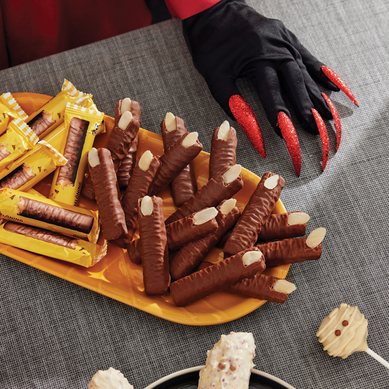 Chocolate biscuits with almonds shaped like witch fingers for Halloween.