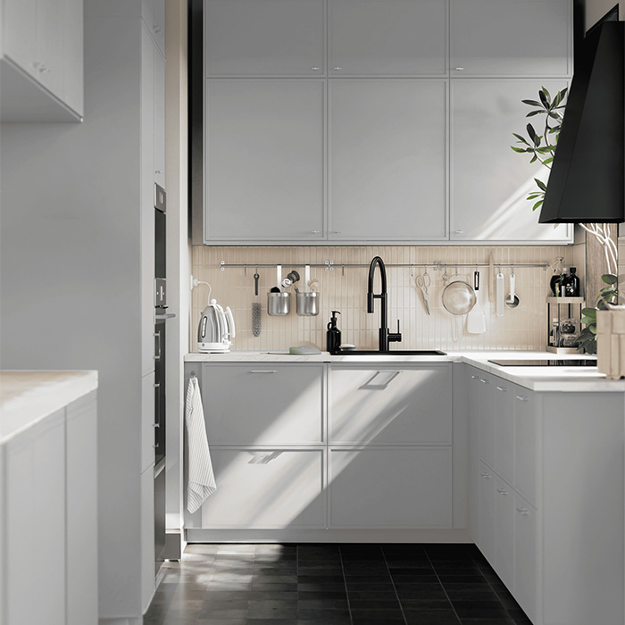 Modern light-toned kitchen with natural sunlight.
